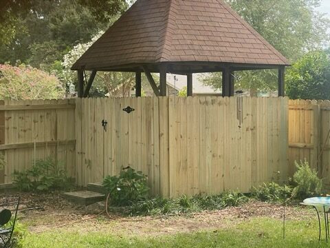 Privacy fence wrapping around a back yard gazebo
